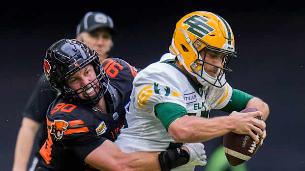 Jun 17, 2023; Vancouver, British Columbia, CAN; BC Lions defensive lineman Mathieu Betts (90) sacks Edmonton Elks quarterback Taylor Cornelius (15) in the second half at BC Place. BC won 22-0. Mandatory Credit: Bob Frid-USA TODAY Sports  